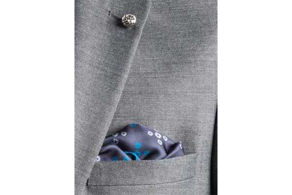 Teal Revolving Knot Silk Pocket Square by Elizabeth Parker in jacket pocket